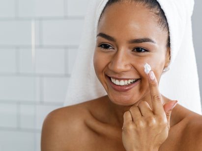 Woman applying face cream