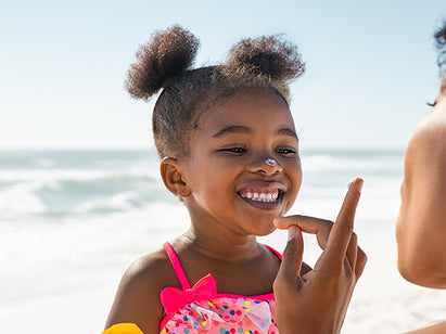 Child with sun cream on face