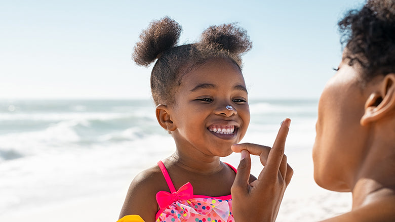 Child with sun cream on face