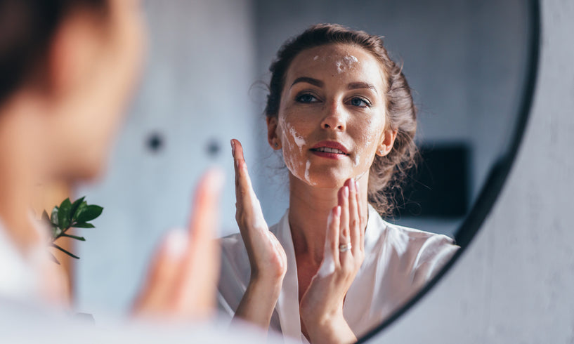 Woman putting face cream on