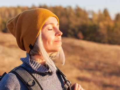 woman out walking - facing the sun light