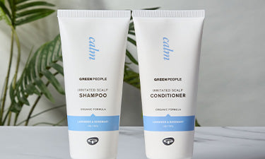 banner featuring irritated scalp shampoo and conditioner with green plants