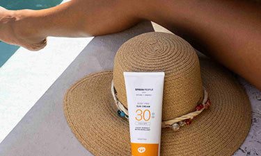 alcohol-free sunscreen and hat by pool