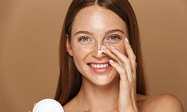 banner for combination skin care with woman applying cream to face