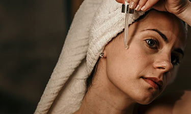 woman applying hyaluronic acid skin care