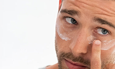 man using men's eye cream