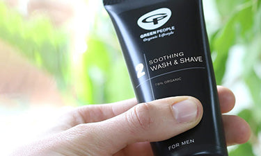 banner for men's organic skin care category featuring man holding wash and shave gel