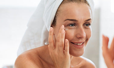 woman applying a microbiome skin care product