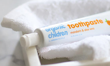 natural baby toothpaste tube on white flannel