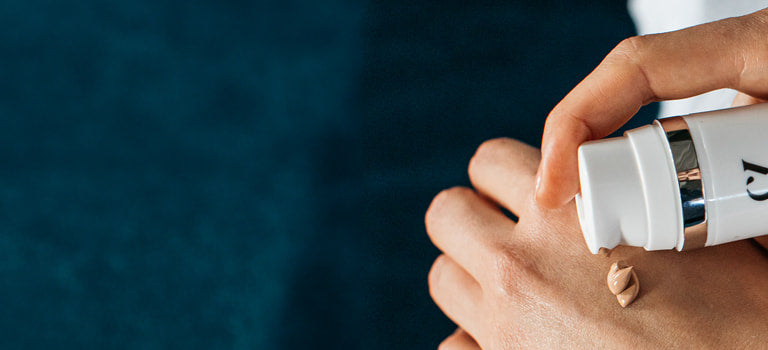 person applying natural make-up for rosacea to back of hand