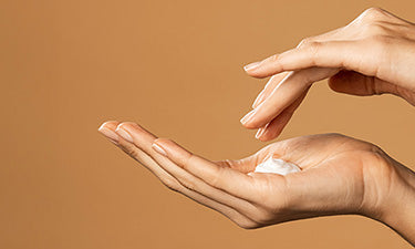 woman applying natural hand care products