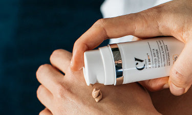 woman applying non-comedogenic foundation to back of hand