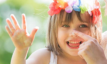 banner for organic sun cream for kids category featuring girl with sun cream on nose