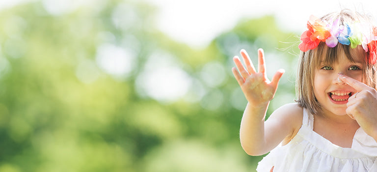 banner for organic sun cream for kids category featuring girl with sun cream on nose