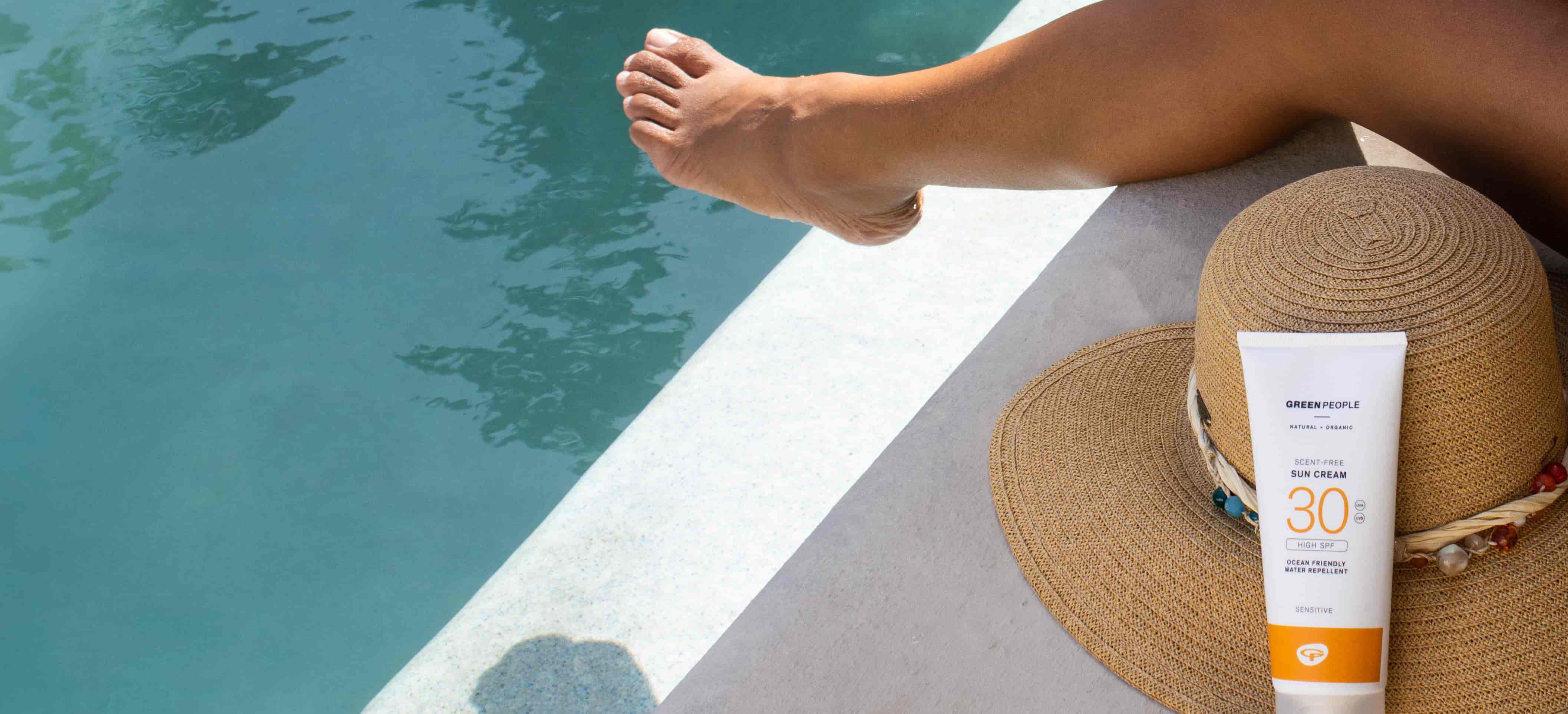 banner for paraben-free sunscreen category with lady sitting by pool