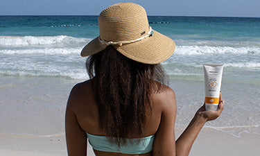 banner for sun cream offers and bundles category featuring woman holding sun cream