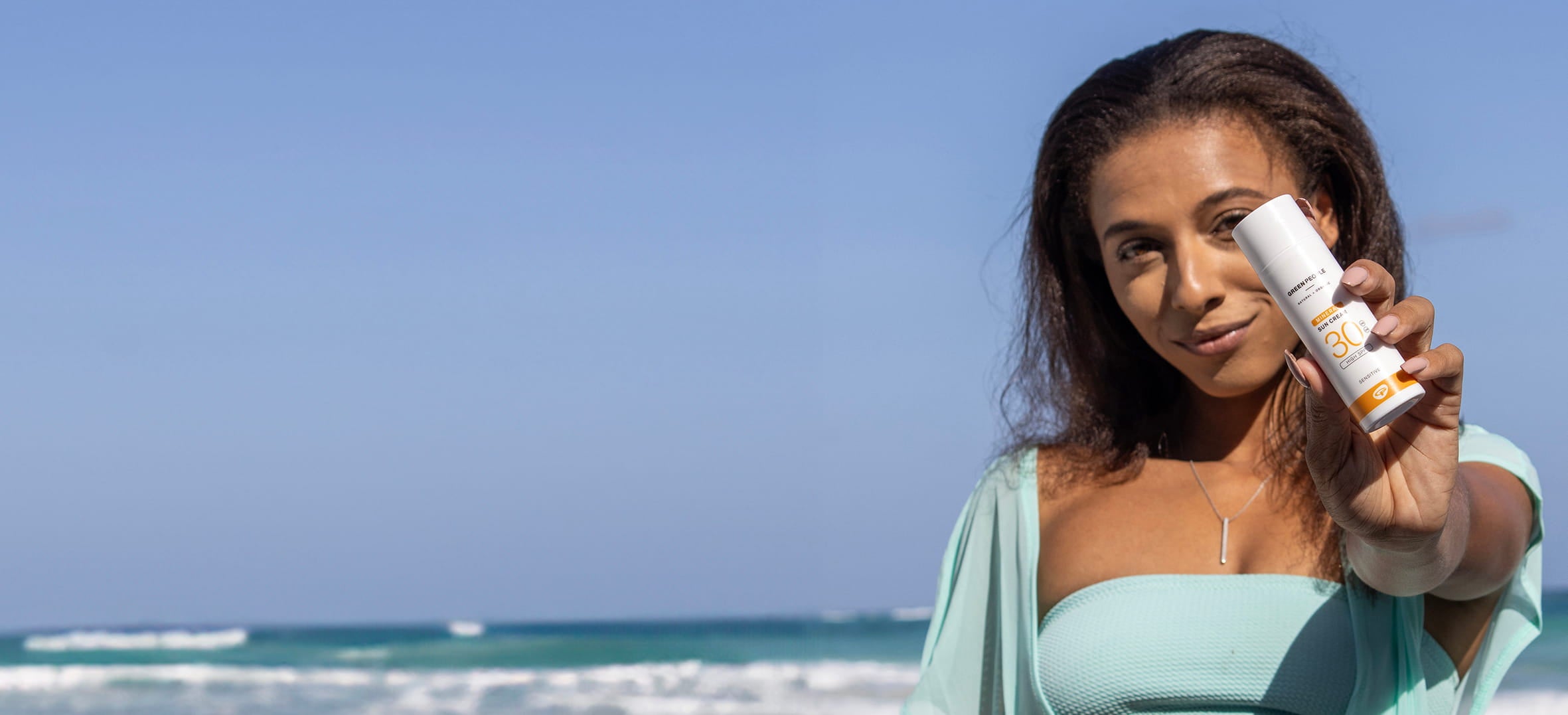 woman holding sunscreen for oily skin